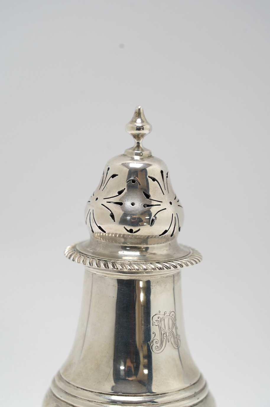 A George V silver inverted pear shaped pedestal sugar caster, Charles Stuart Harris & Sons, London, 1911, 21.6cm, 6.5oz. Condition - fair